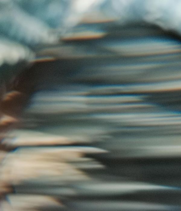 Abstract image with flowing lines of light blue and beige colors.